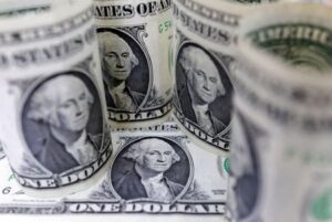 Dollar dips as Fed flags stalled inflation progress
