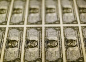 Dollar calm as Fed urges patience; kiwi surges on hawkish RBNZ outlook