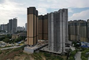 China's new home prices inch up for 9th month in May, survey shows