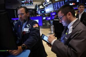 Trade fears hamper tech stocks, dollar falls amid rate cut talk