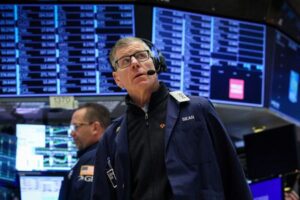 Nasdaq lags peers as Netflix, chip stocks drag; AmEx lifts Dow